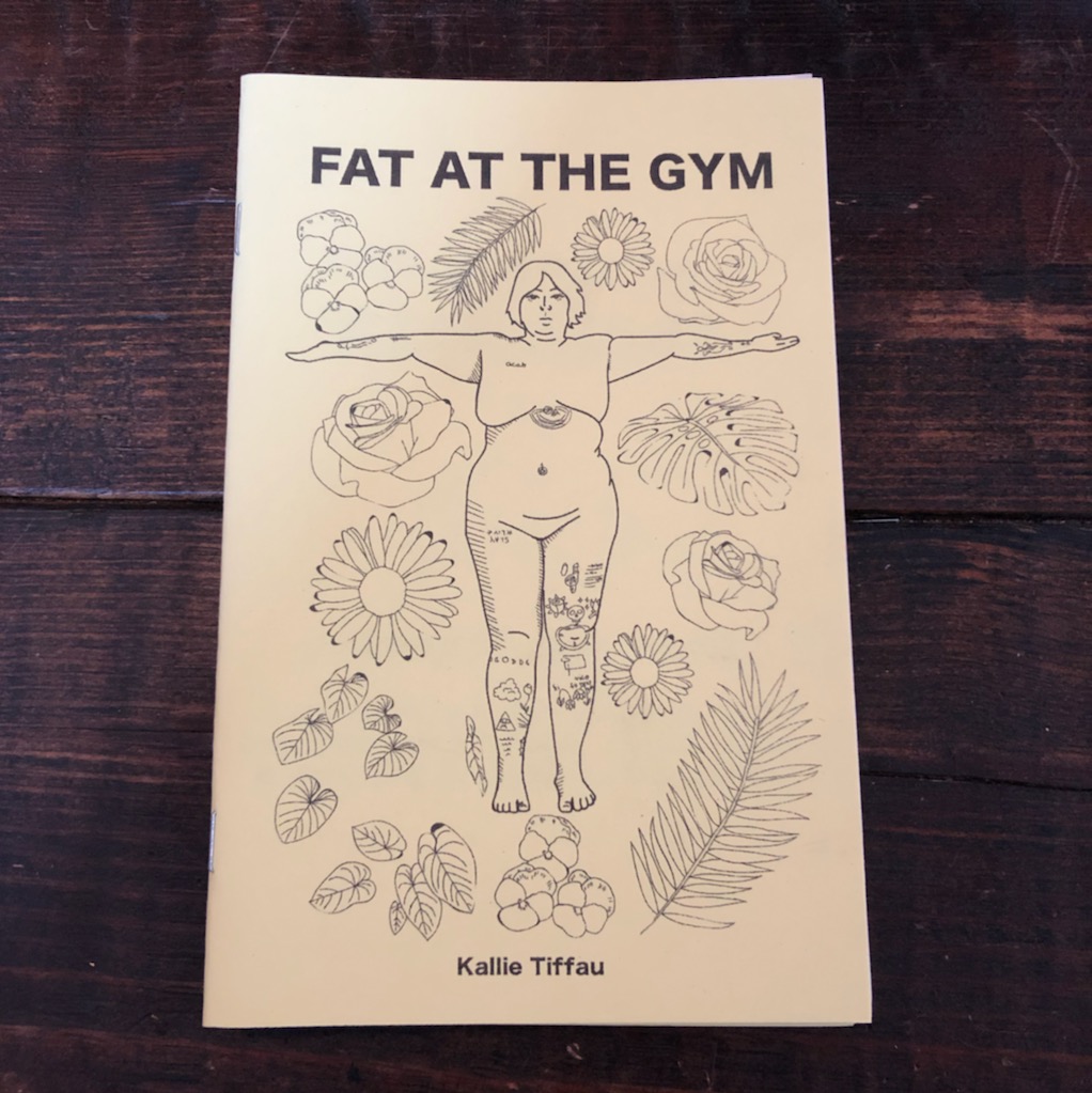 photo of zine: nude, tattooed fat person with arms out