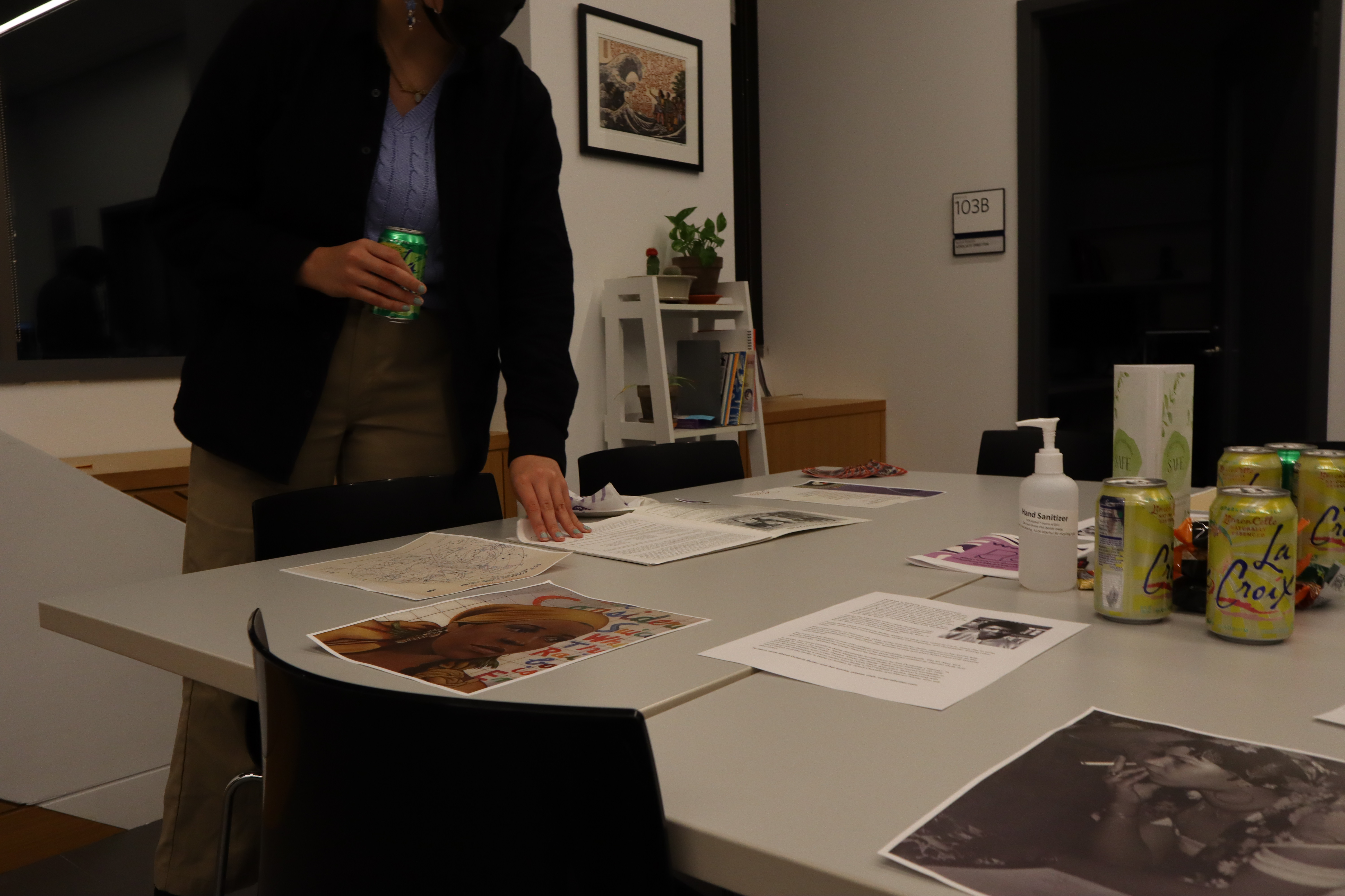 Person looking through archival materials during the DHC Collage installation