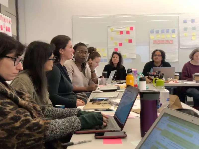 Classroom of women with laptops in front of them